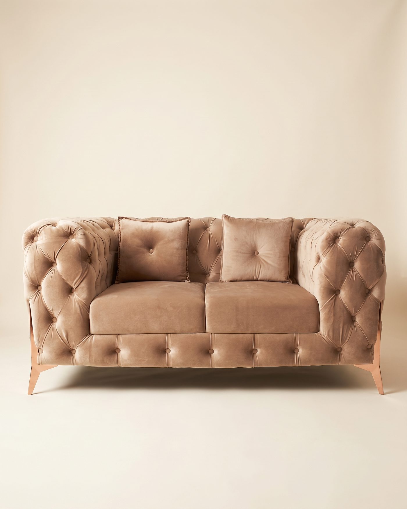 Blush tufted loveseat, studio photo