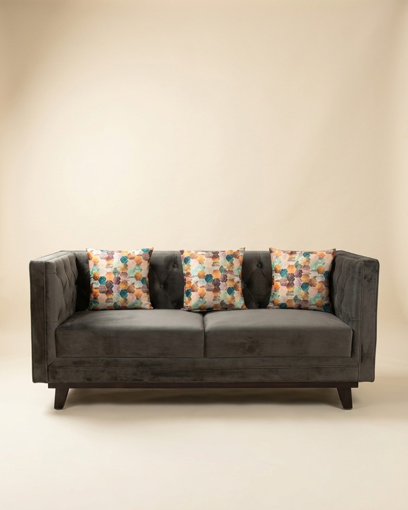 Charcoal tufted sofa, studio photo