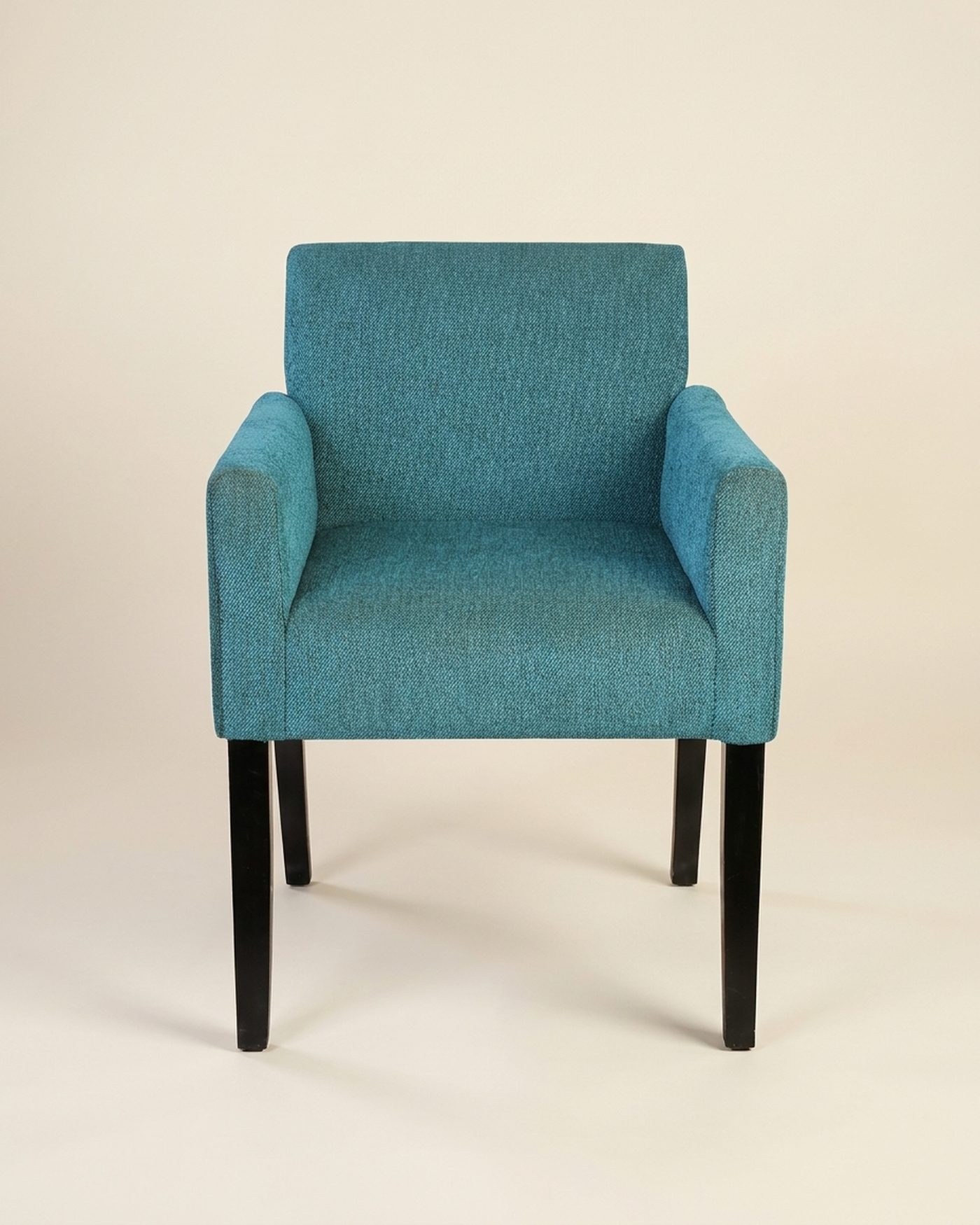 Seafoam upholstered armchair, studio photo