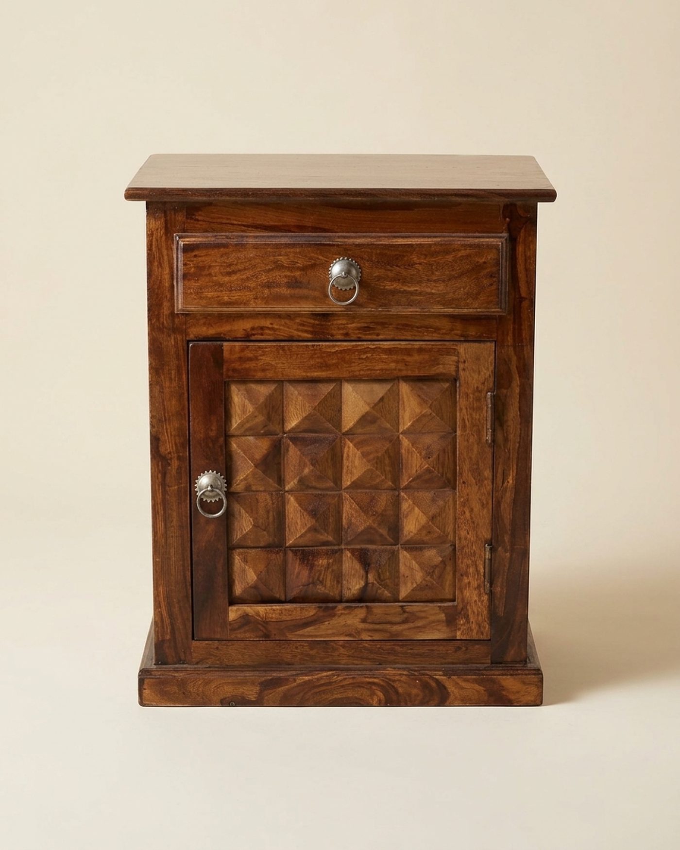 Stud carved bedside cabinet, studio photo