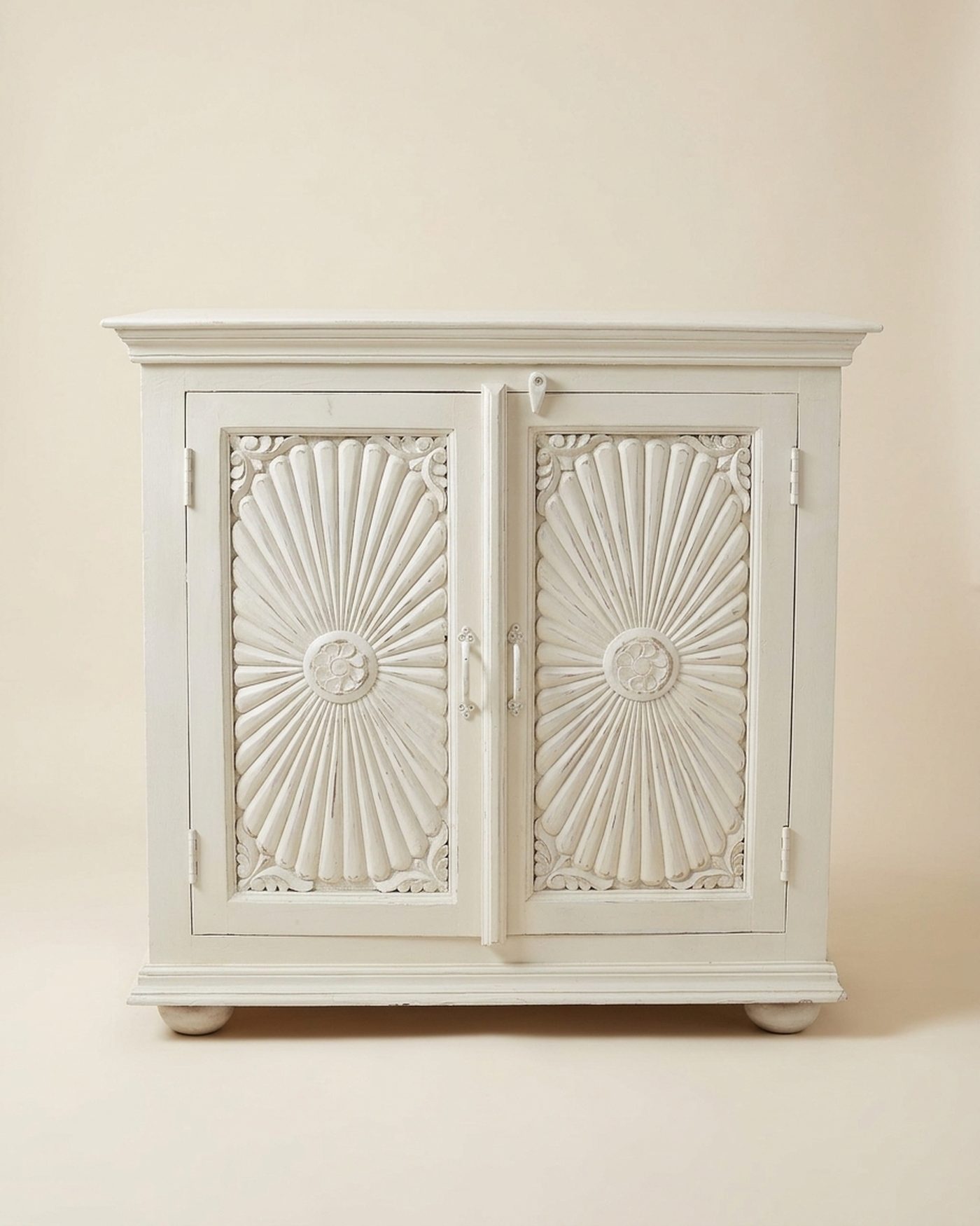 Sunburst carved white cabinet, studio photo