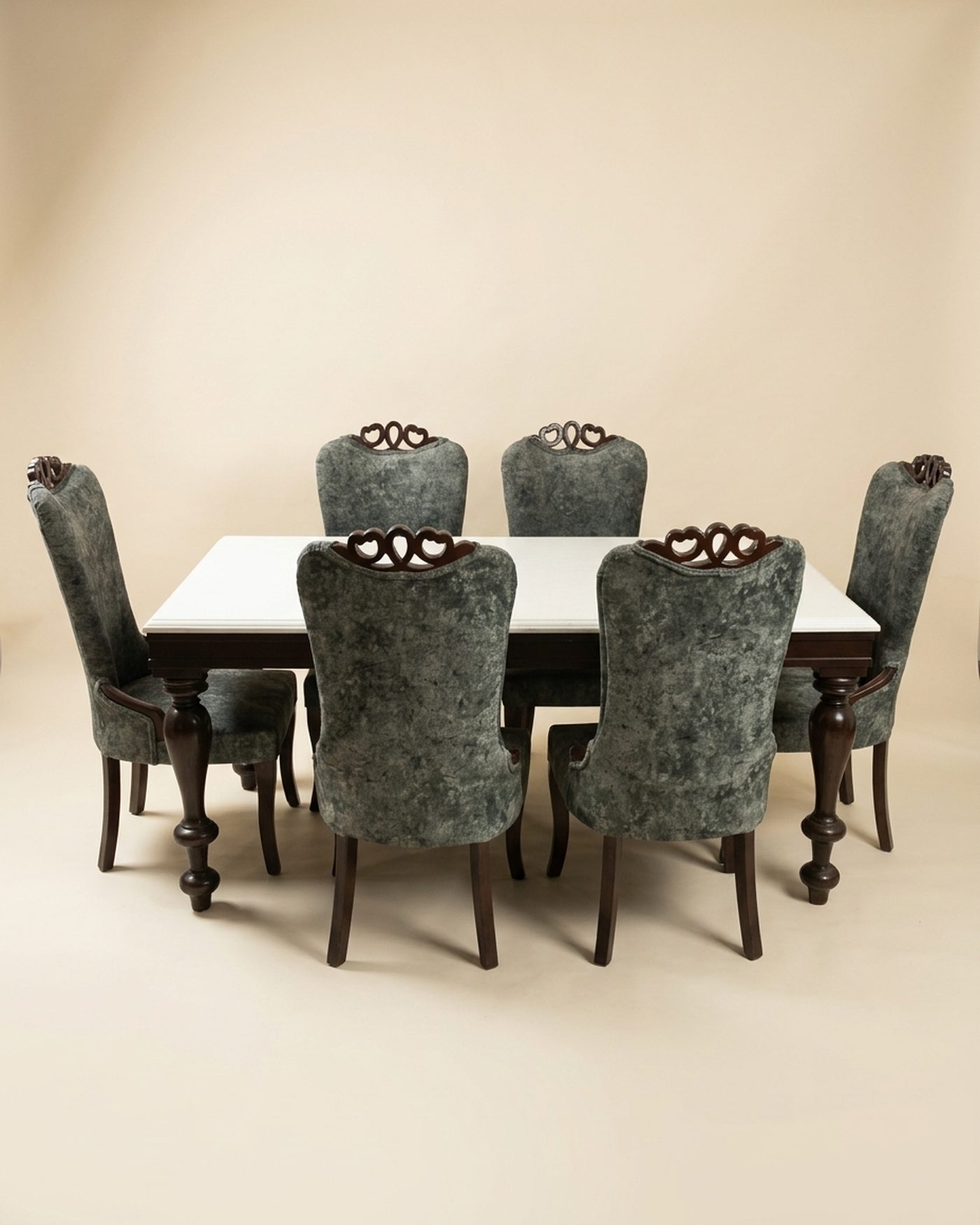 Silver dining set with carved chairs, studio photo