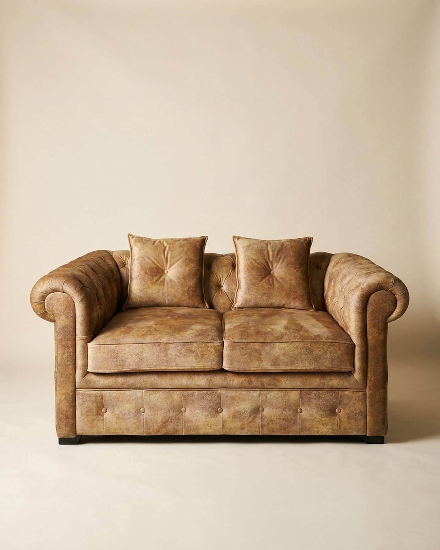 Bronze chesterfield loveseat, studio photo