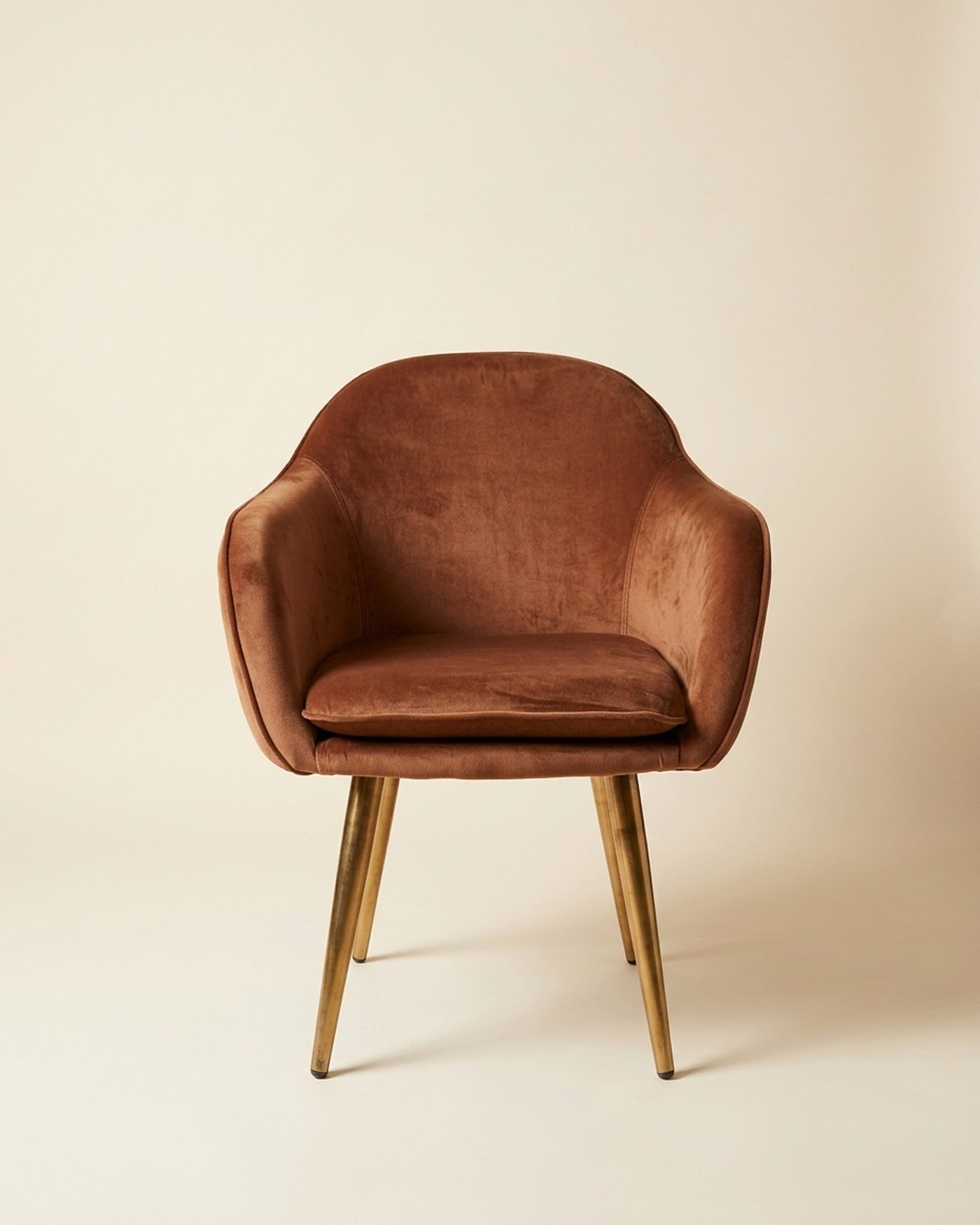 Rust velvet tub chair, studio photo
