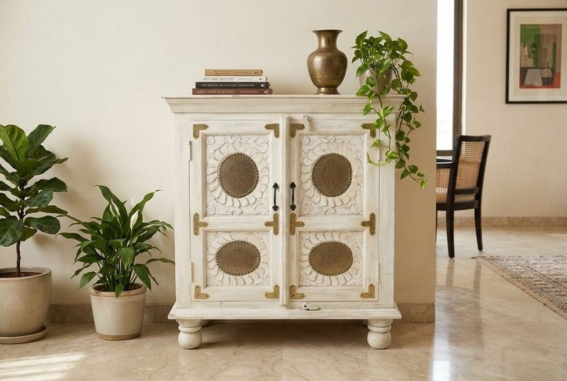 Brass Moon white cabinet with brass medallions in a styled room